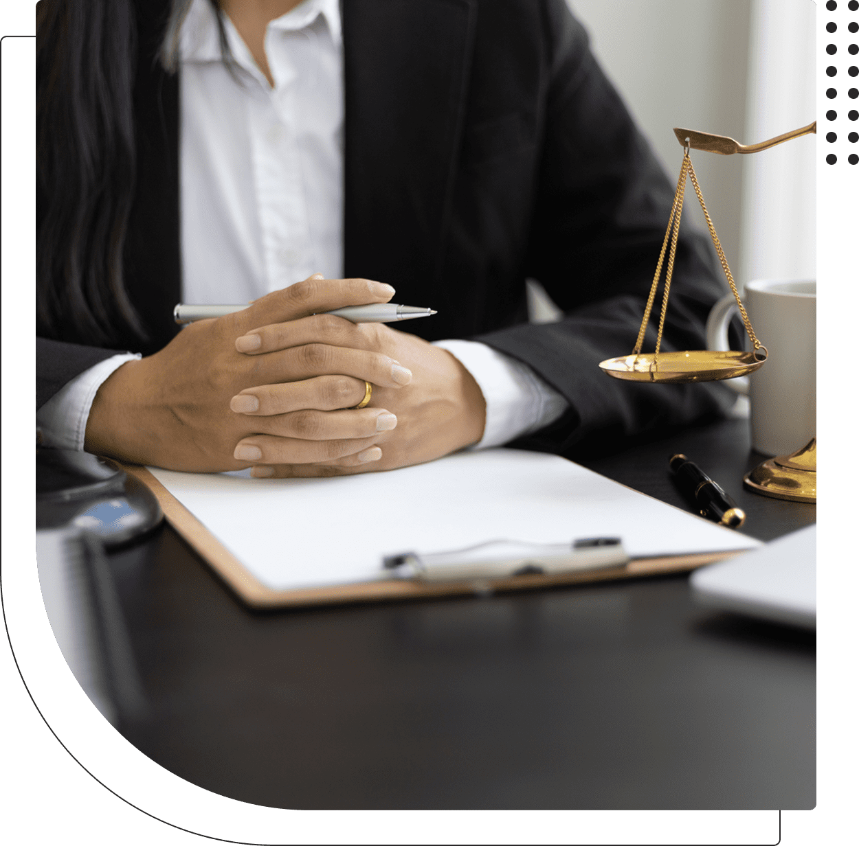 Lawyer with scales of justice on desk.