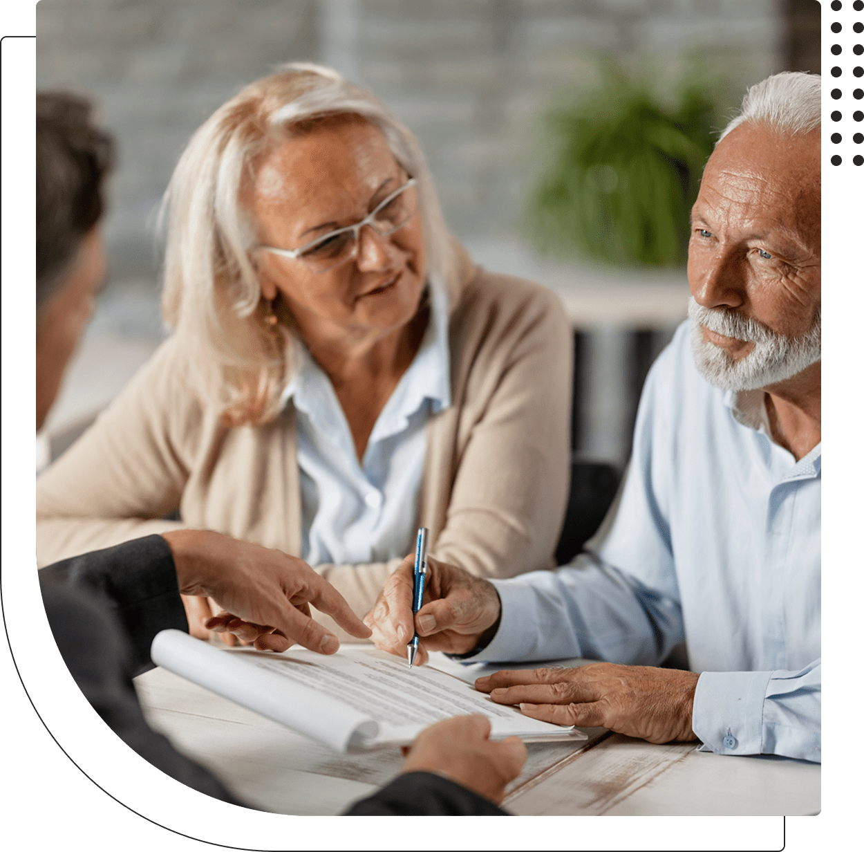 Older couple reviewing documents with advisor.