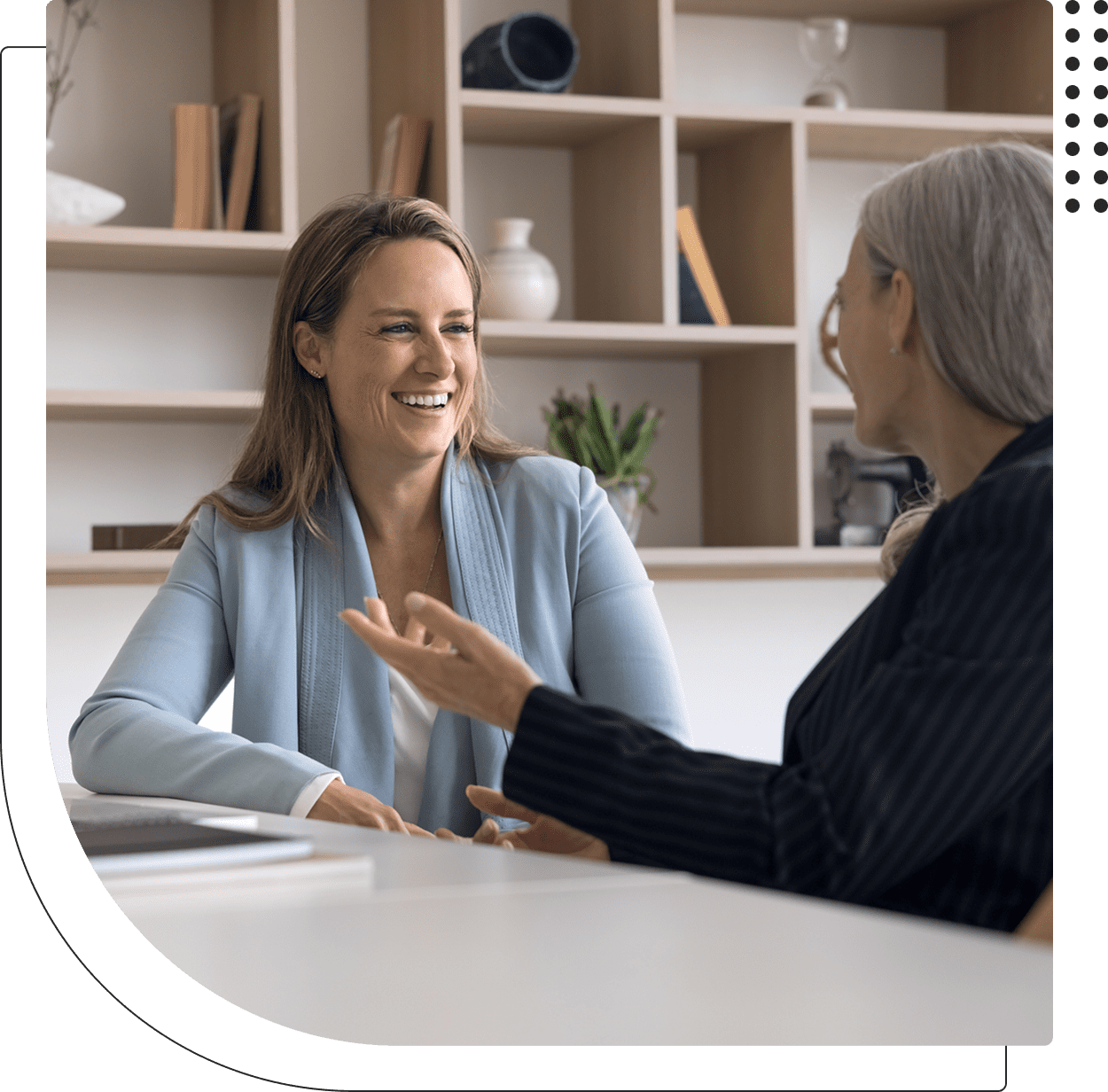 Two women having a discussion, smiling.