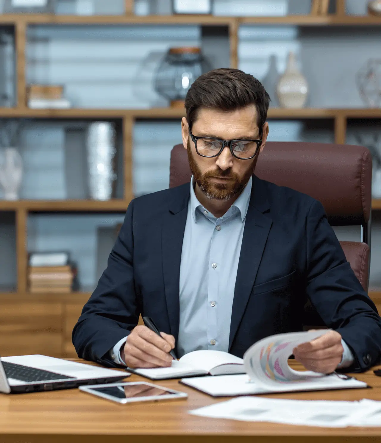Man working at desk with documents.